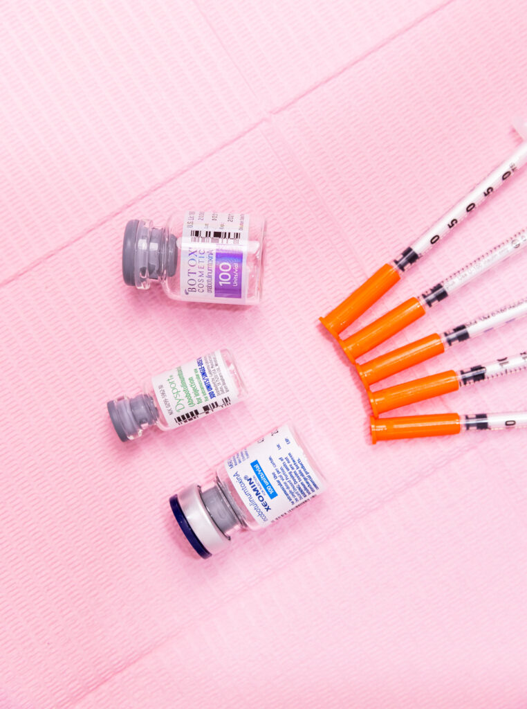 Alt Text: A vial of Botox near Cairo, GA, sits alongside other wrinkle relaxers on a sterile worksurface.