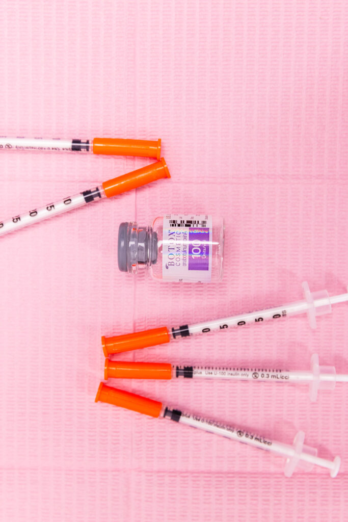 Our Botox injections in Tallahassee sit on a sterile drop cloth. There is a vial of Botox, surrounded by ultrafine syringes with their caps still on.