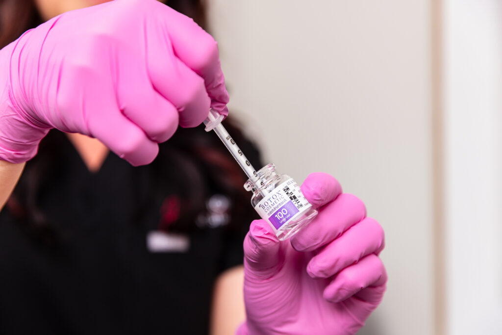  Harmonized Aesthetics' expert injector, Harmony, prepares several units of wrinkle relaxers, wearing surgical gloves. In recent years, Botox for men in Tallahassee has become an increasingly popular treatment for addressing the signs of aging while maintaining masculine features.